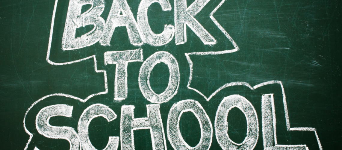 chalkboard with the words back to school on to accompany fire protection compliance for schools blog